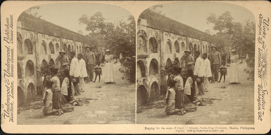 Praying for the souls of departed friends – Santa Cruz Cemetery, Manila, Philippines.